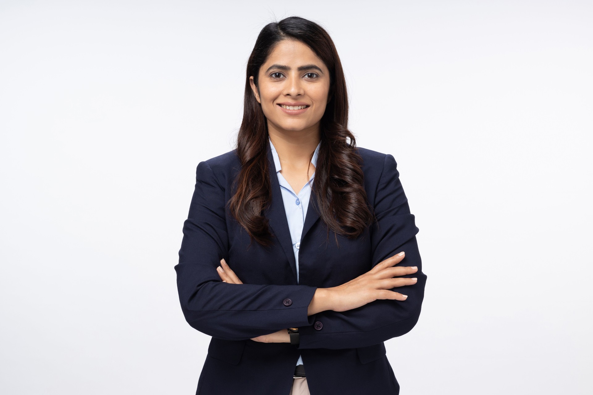 Portrait of happy young businesswoman arms crossed  with looking at camera on white background stock photo